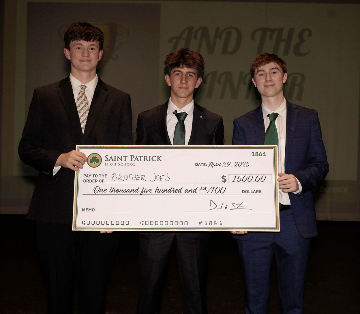 The founders holding a $1,500 check from Saint Patrick High School made out to Brother Joe's